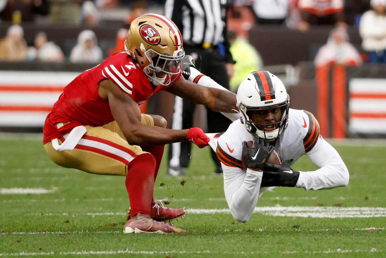 San Francisco 49ers cornerback Charvarius Ward tackles Browns wide receiver David Bell, Sunday, Oct. 15, 2023, in Cleveland.