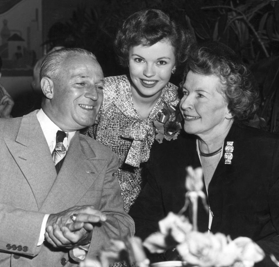 <p>Shirley's parents, Gertrude and George Temple, accompany her to a 20th Century Fox party to celebrate her return to the studio in <em>Mr. Belvedere Goes to College.</em> </p>