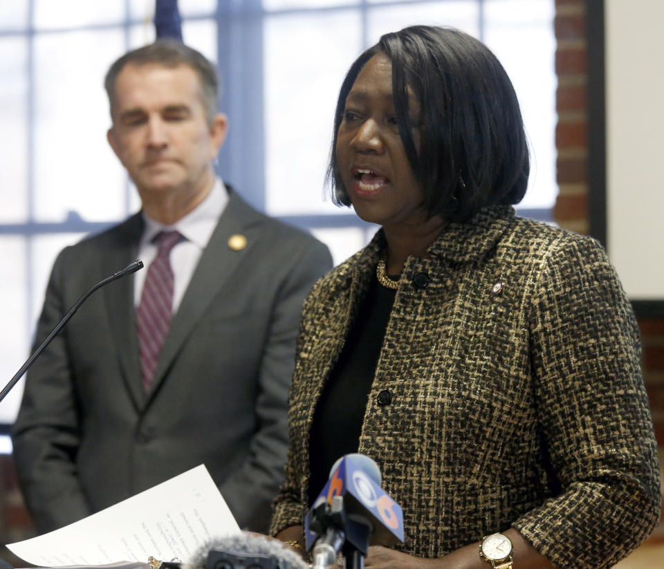 As Gov. Ralph Northam, left, looks on, Chief Deputy Attorney General Cynthia Hudson, left, addresses a gathering as she presented the report from The Commission to Examine Racial Inequity in Virginia Law in Richmond, Va., Thursday, Dec. 5, 2019. (Bob Brown/Richmond Times-Dispatch via AP)