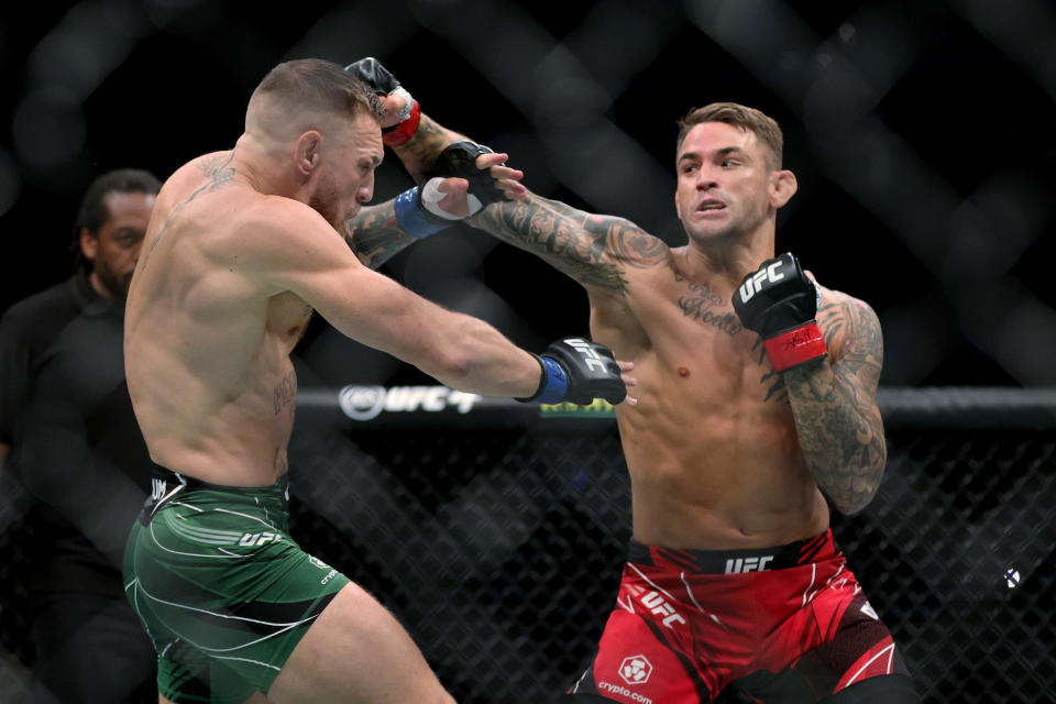 LAS VEGAS, NEVADA - JULY 10: Dustin Poirier (R) lands a punch on Conor McGregor of Ireland in the first round in their lightweight bout during UFC 264: Poirier v McGregor 3 at T-Mobile Arena on July 10, 2021 in Las Vegas, Nevada. (Photo by Stacy Revere/Getty Images)
