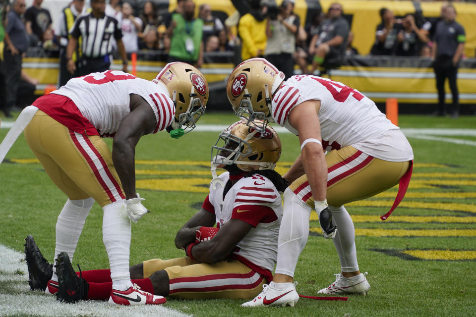 San Francisco 49ers wide receiver Brandon Aiyuk, center, celebrates with Deebo Samuel, left, and Kyle Juszczyk after scoring a touchdown against the Pittsburgh Steelers during the first half of an NFL football game Sunday, Sept. 10, 2023, in Pittsburgh. (AP Photo/Gene J. Puskar)