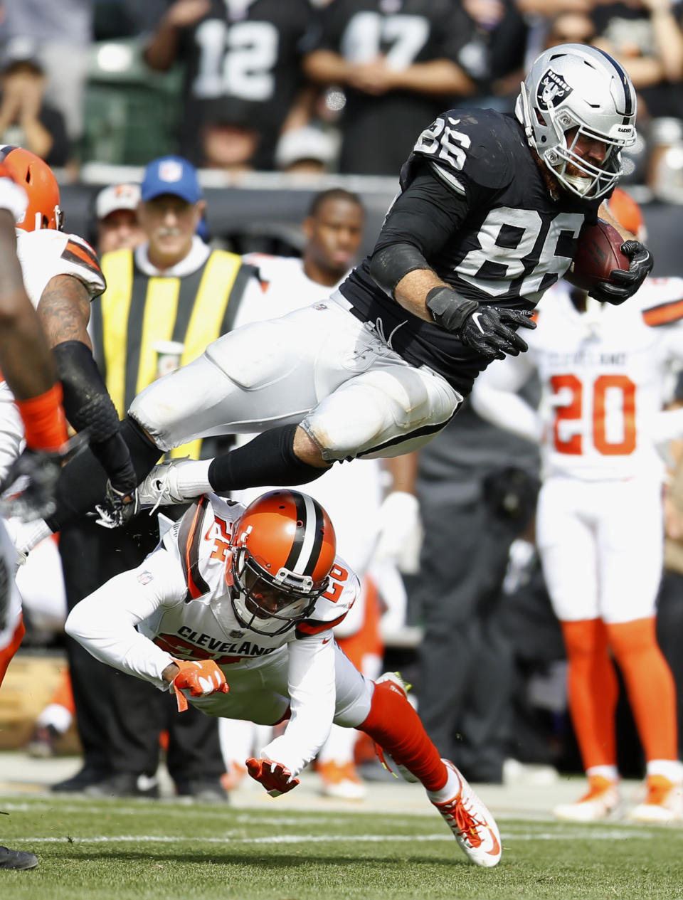 Oakland Raiders tight end Lee Smith (86) is tackled by Cleveland Browns defensive back E.J. Gaines (28) during the first half of an NFL football game in Oakland, Calif., Sunday, Sept. 30, 2018. (AP Photo/D. Ross Cameron)