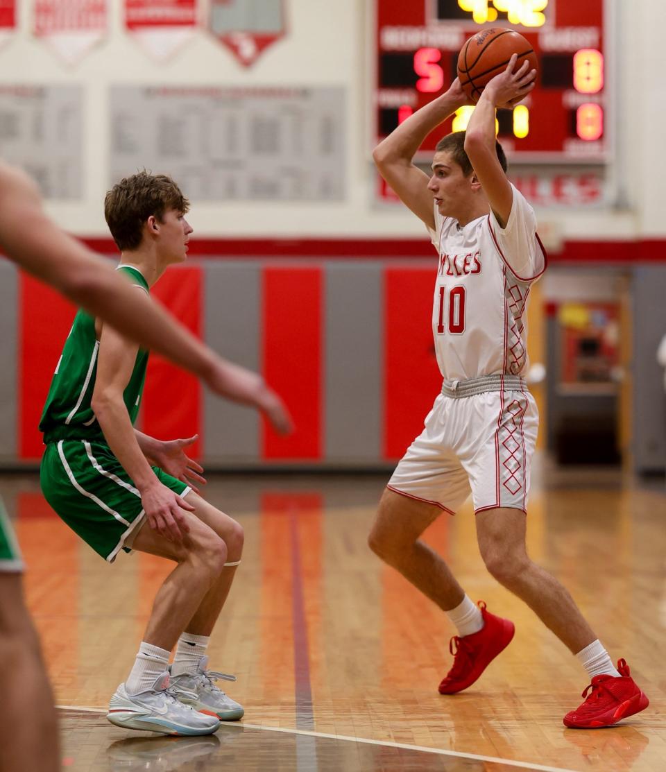 Carter Ryan of Bedford looks to pass with St. Mary Catholic Central’s Ian Foster guarding during a 58-52 Bedford win Friday night.