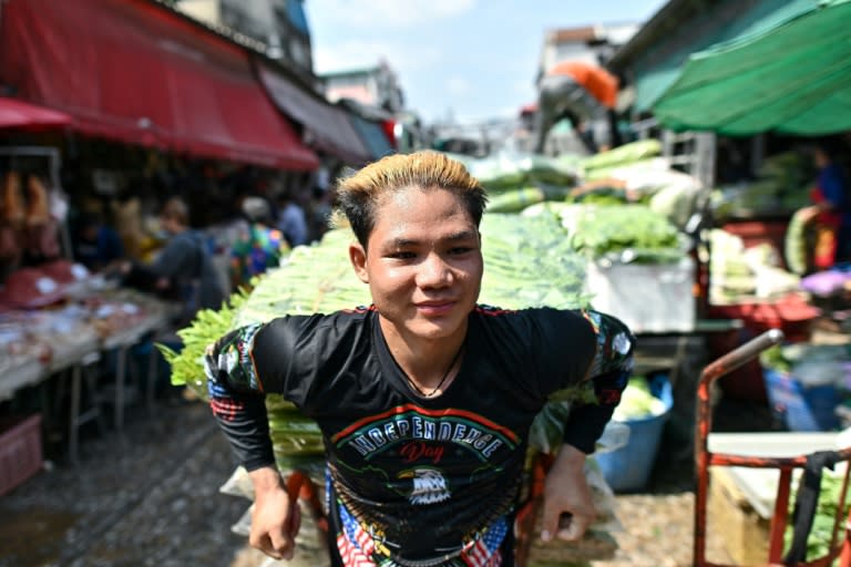 A vendor sweats as he pulls a vegetable cart at Khlong Toei Market in Bangkok on Thursday (MANAN VATSYAYANA)