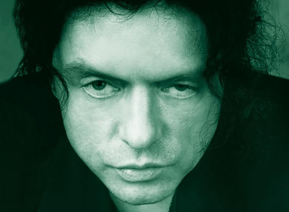 Movie poster of "The Room" featuring Tommy Wiseau with intense expression. Text includes cast and release info