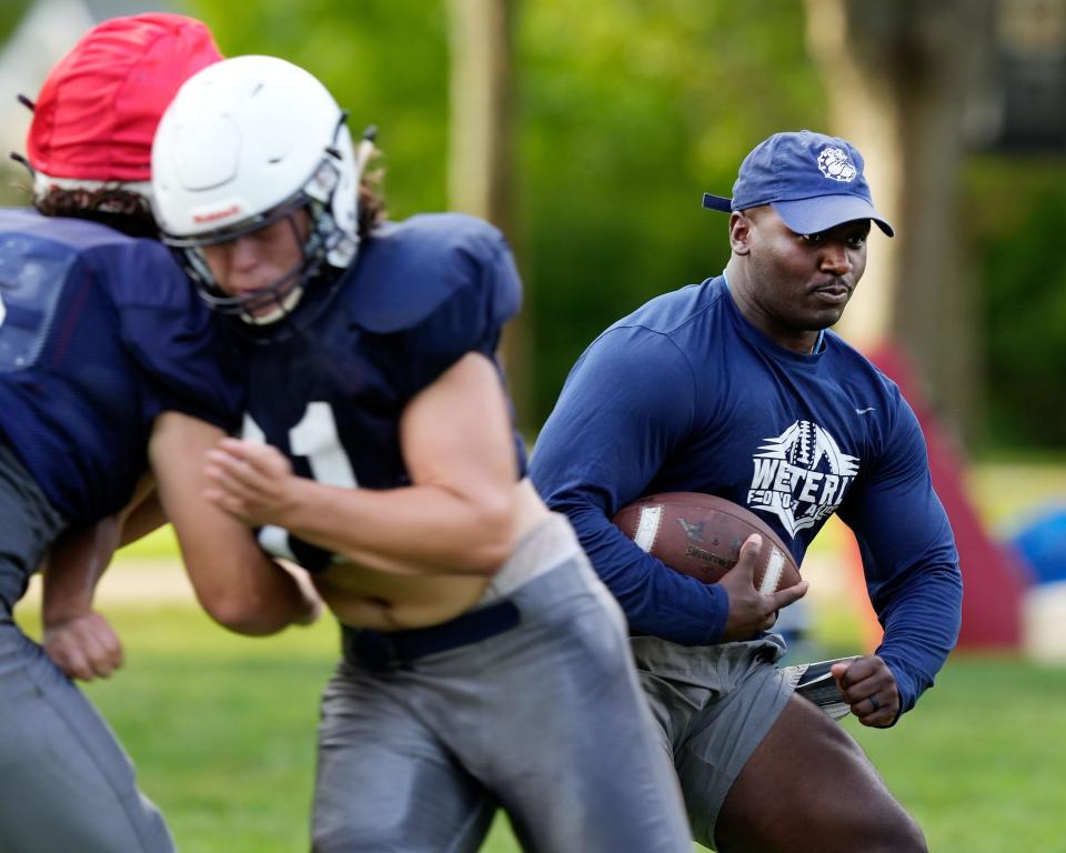Westerly head football coach Stanley Dunbar participates in a drill during practice.