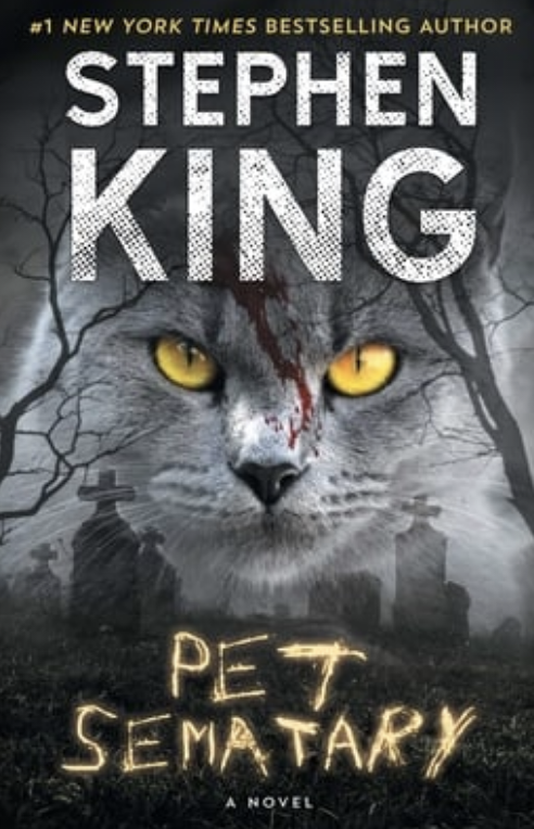 Book cover of Stephen King's "Pet Sematary" with a cat's face and a spooky backdrop