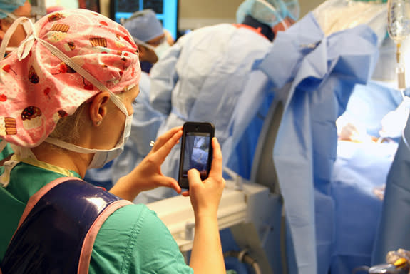 A nurse takes a photo during a recent surgery on an 8-year-old boy at Arnold Palmer Hospital for Children in Orlando, Florida. Doctors there have developed an app that allows nurses to safely and securely send texts, photos and videos from the