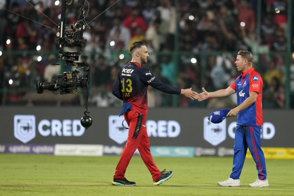 Delhi Capitals' captain David Warner, right, shakes hands with Royal Challengers Bangalore's captain Faf du Plessis to congratulate him on their win in the Indian Premier League cricket match between Royal Challengers Bangalore and Delhi Capitals in Bengaluru, India, Saturday, April 15, 2023. (AP Photo/Aijaz Rahi)