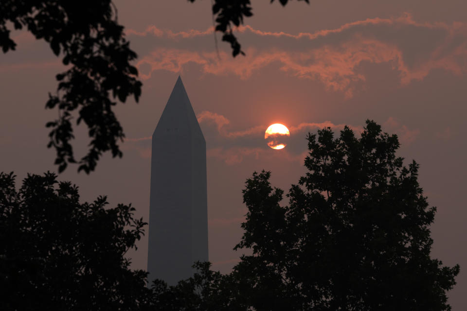 The Washington Memorial stands in hazy smoke.