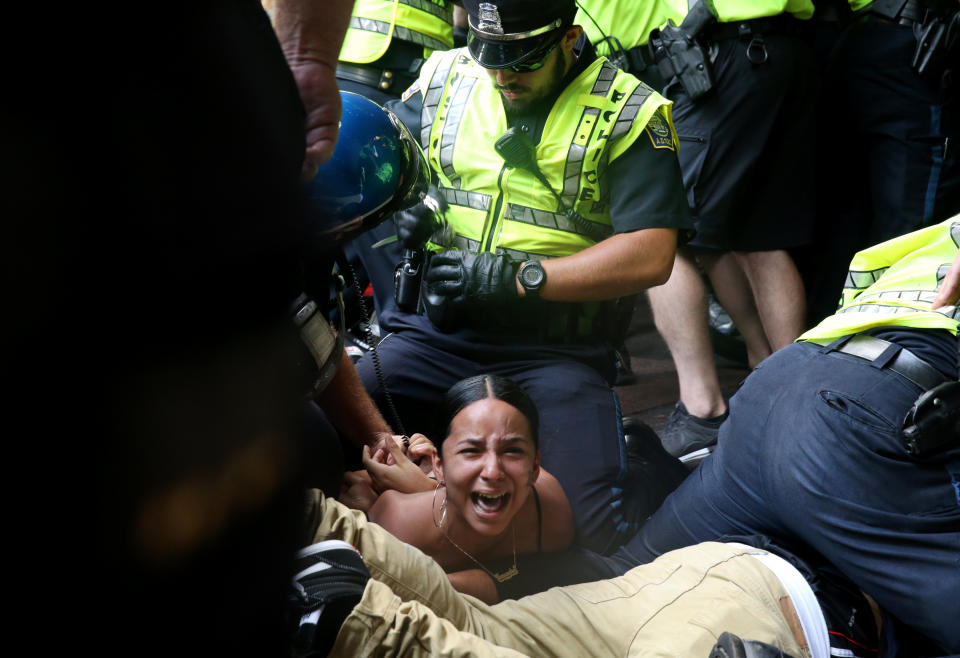 A woman is arrested during a confrontation on Washington Street following the "Boston Free Speech" rally and counterprotest on Aug. 19, 2017.