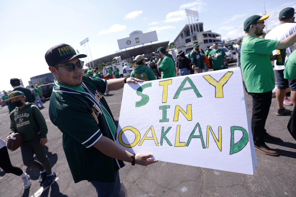 Reuben Ortiz of Modesto, Calif., holds a sign outside Oakland Coliseum to protest the Oakland Athletics' planned move to Las Vegas, before a baseball game between the Athletics and the Tampa Bay Rays in Oakland, Calif., Tuesday, June 13, 2023. (AP Photo/Jed Jacobsohn)
