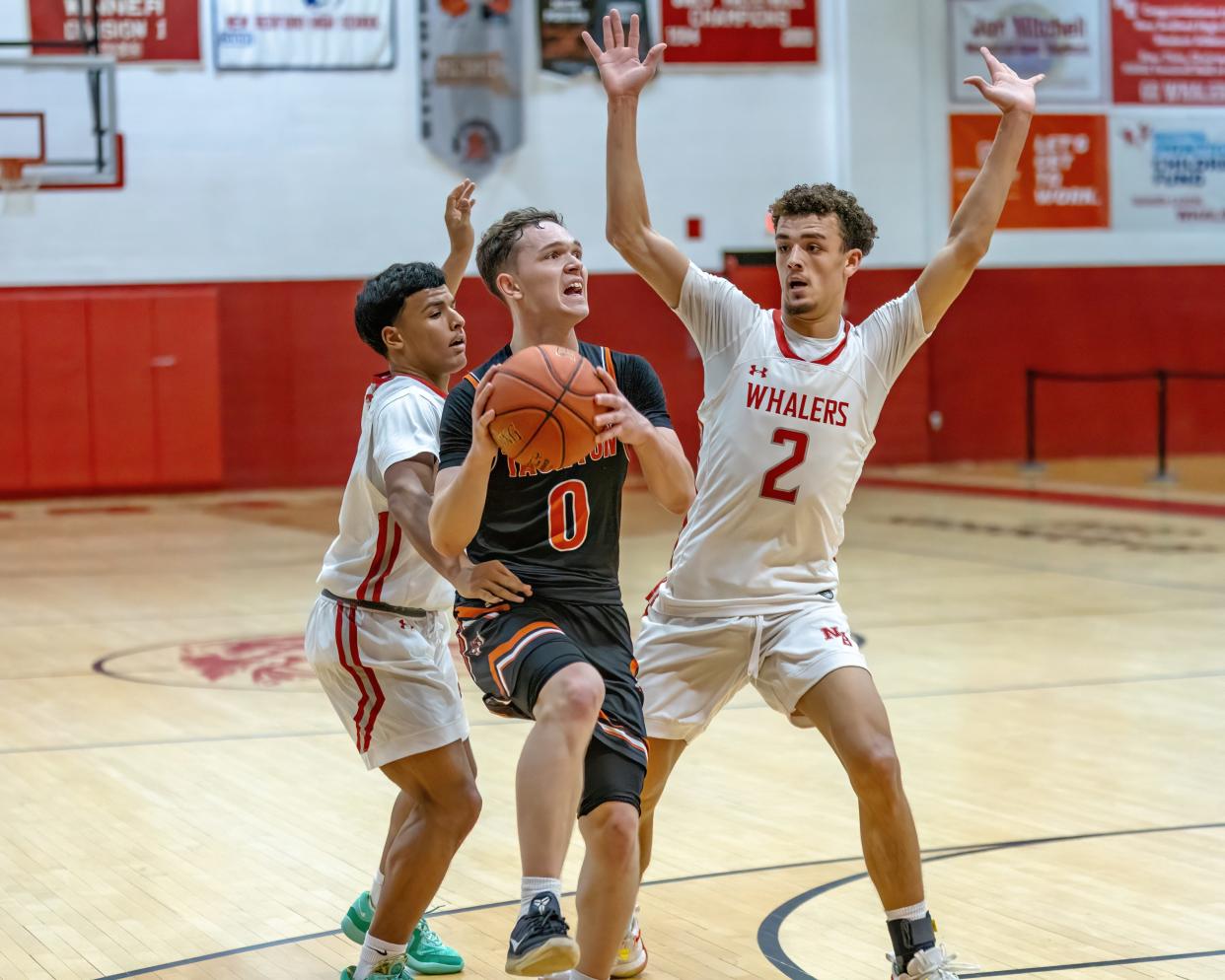 Dezmond Brunskill (2) of New Bedford High School and teammate Marquize Gonsalves attempt to deny Taunton Point Guard Troy Santos (0) access to the basket.