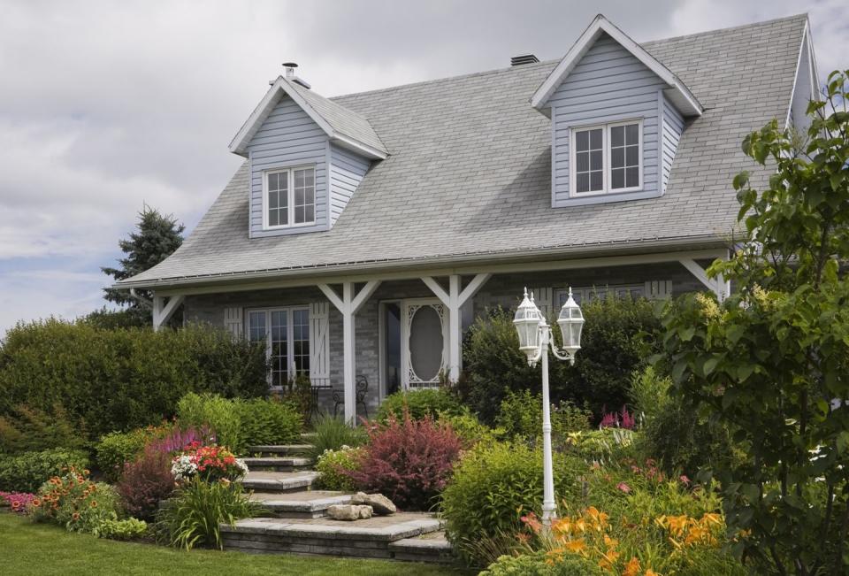 <p>Instead of stairs up to a front porch, consider building an elevated stone walkway to the front of your home. Frame them with an abundance of bushes and flowers.</p><p><strong> <a href="https://www.countryliving.com/home-maintenance/g31970500/front-step-ideas/" rel="nofollow noopener" target="_blank" data-ylk="slk:Read more DIY front step ideas;elm:context_link;itc:0;sec:content-canvas" class="link ">Read more DIY front step ideas</a>. </strong></p>