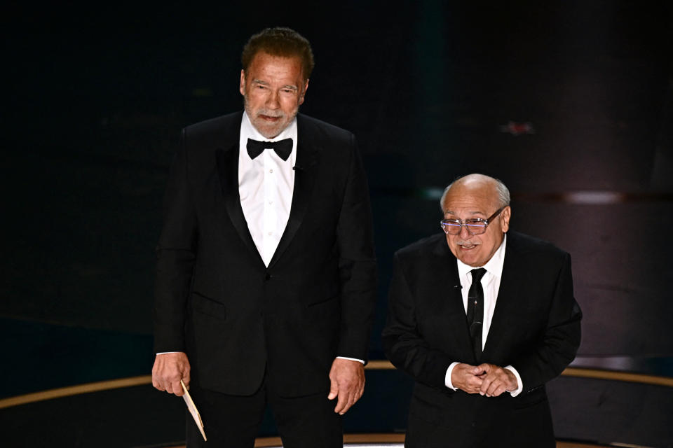 US actor Danny DeVito (R) and Austrian-US actor and former Governor of California Arnold Schwarzenegger present the award for Best Visual Effects onstage during the 96th Annual Academy Awards at the Dolby Theatre in Hollywood, California on March 10, 2024. (Photo by Patrick T. Fallon / AFP) (Photo by PATRICK T. FALLON/AFP via Getty Images)