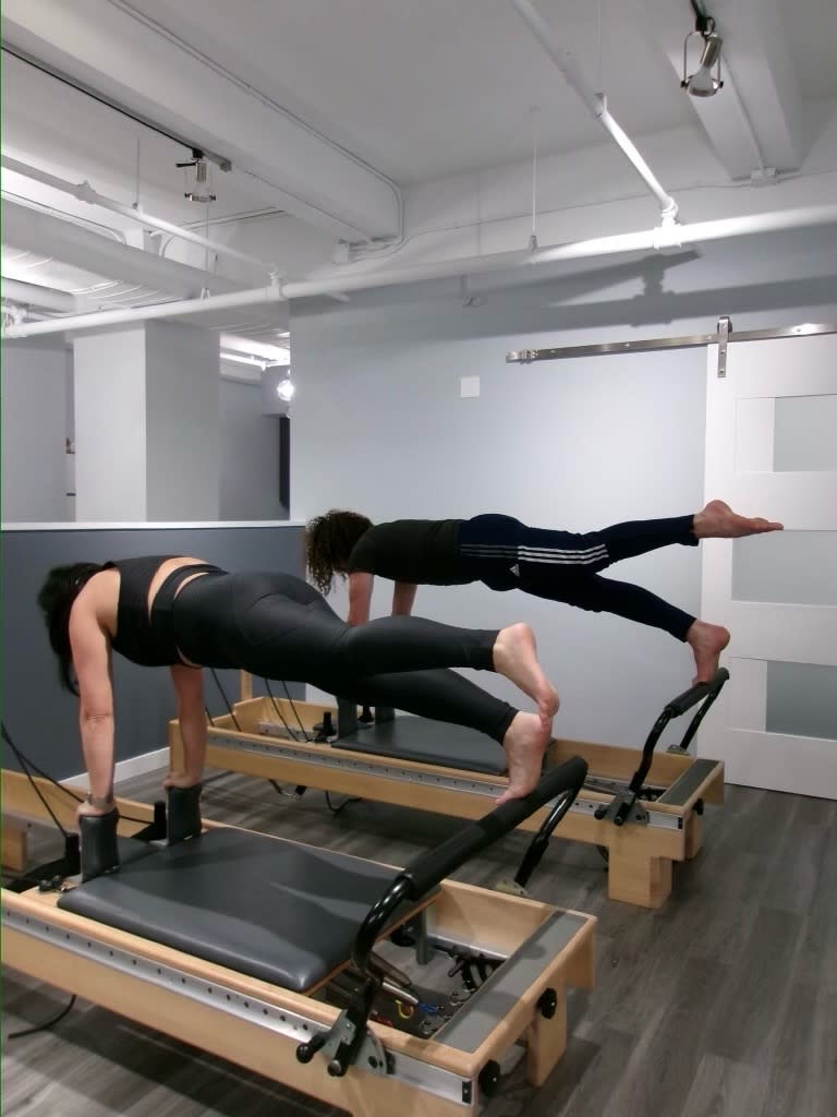 People doing pilates at 212 Pilates in New York City. 
