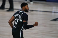 Brooklyn Nets guard Garrett Temple (17) celebrates three-point basket in the closing seconds to defeat the Milwaukee Bucks 119-116 in an NBA basketball game Tuesday, Aug. 4, 2020 in Lake Buena Vista, Fla. (AP Photo/Ashley Landis)