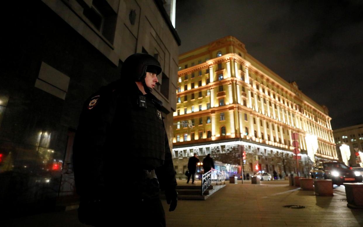A security officer blocks a street near the Federal Security Service building - REUTERS