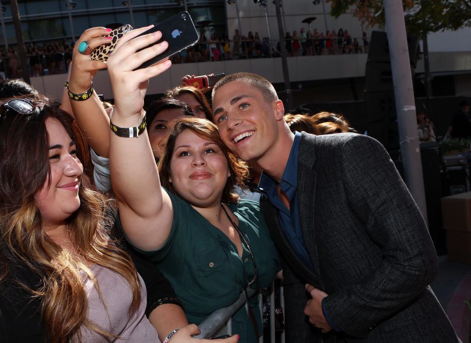 Colton Haynes poses for a selfie with a fan at the 2012 MTV Video Music Awards in Los Angeles.