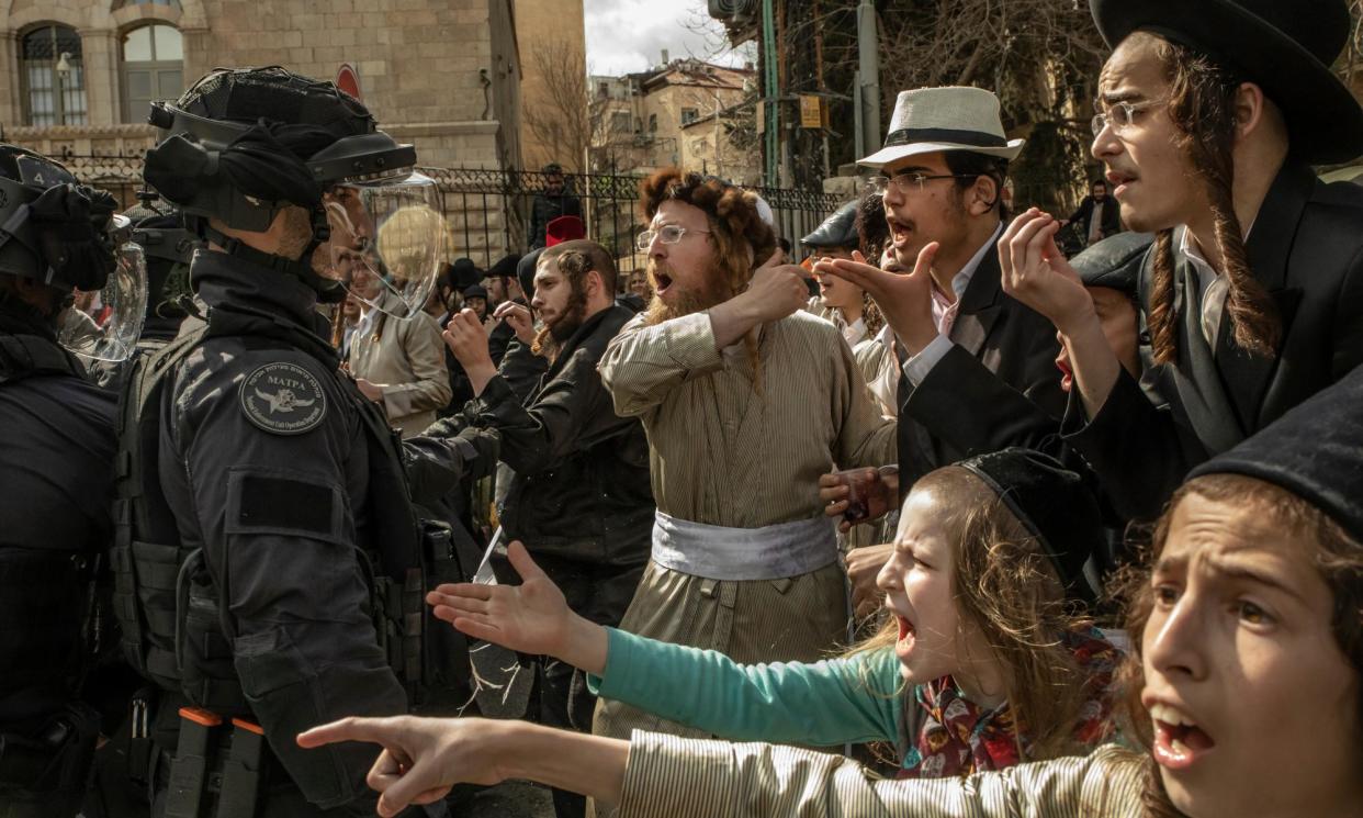 <span>Israeli police face ultra-Orthodox Jewish demonstrators at a protest against conscription into the armed forces in Jerusalem. </span><span>Photograph: Alessio Mamo/The Guardian</span>