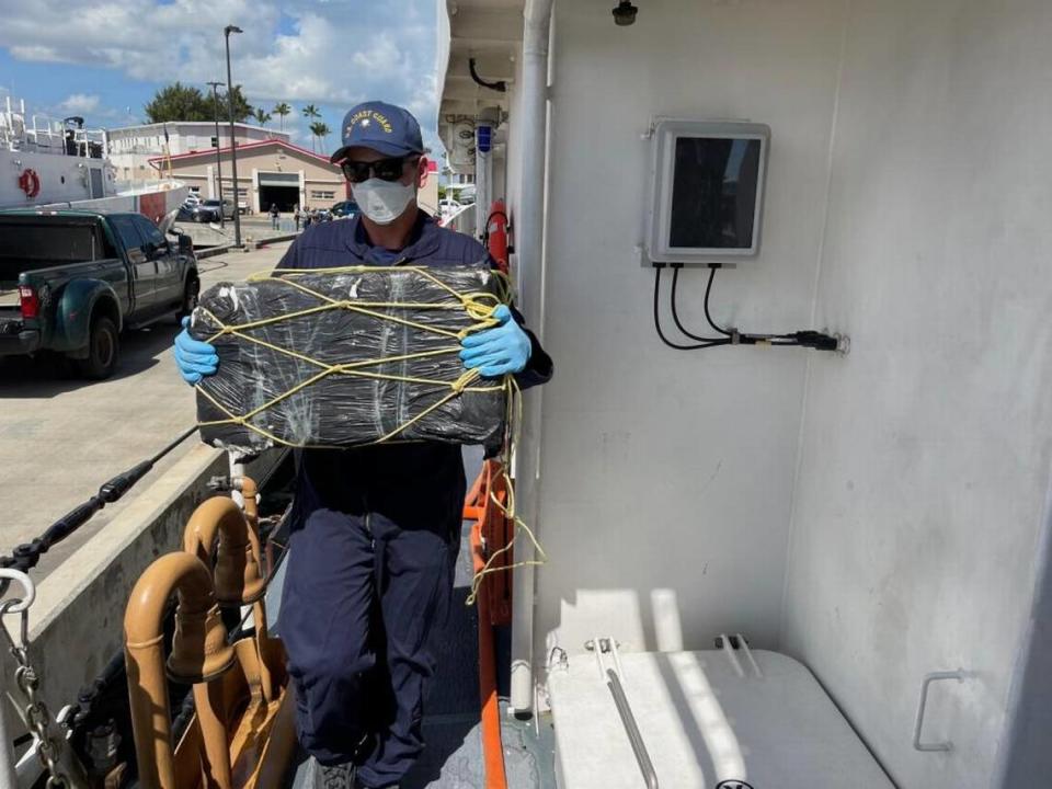 A Coast Guard Cutter Donald Horsley crewmember helps offload approximately 1,000 kilograms of seized cocaine, valued at $20 million, at Coast Guard Base San Juan on April 4, 2022, following the interdiction of a go-fast vessel March 30, 2022 in the Caribbean Sea near Puerto Rico.