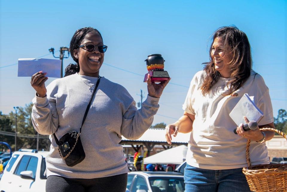 Michelle Weatherford Usry presents the first place chili cook off award to ToRonda Heggs.