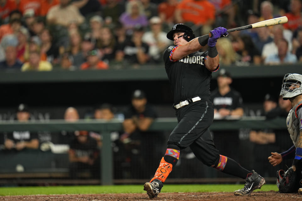 Baltimore Orioles' James McCann connects for a two-run double to score Colton Cowser and Ramon Urias in the sixth inning of a baseball game against the New York Mets, Friday, Aug. 4, 2023, in Baltimore. (AP Photo/Julio Cortez)