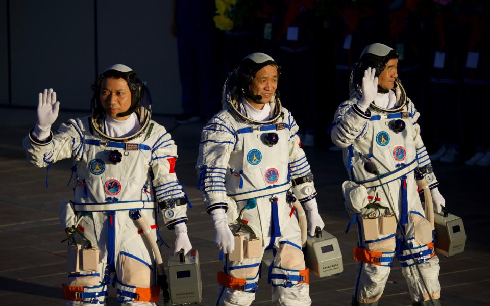 Astronauts (L-R) Tang Hongbo, Nie Haisheng, and Liu Boming depart for the launch site -  Visual China Group