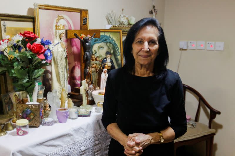 FILE PHOTO: Najla Uchi poses for a photo on her altar in her home in Manama