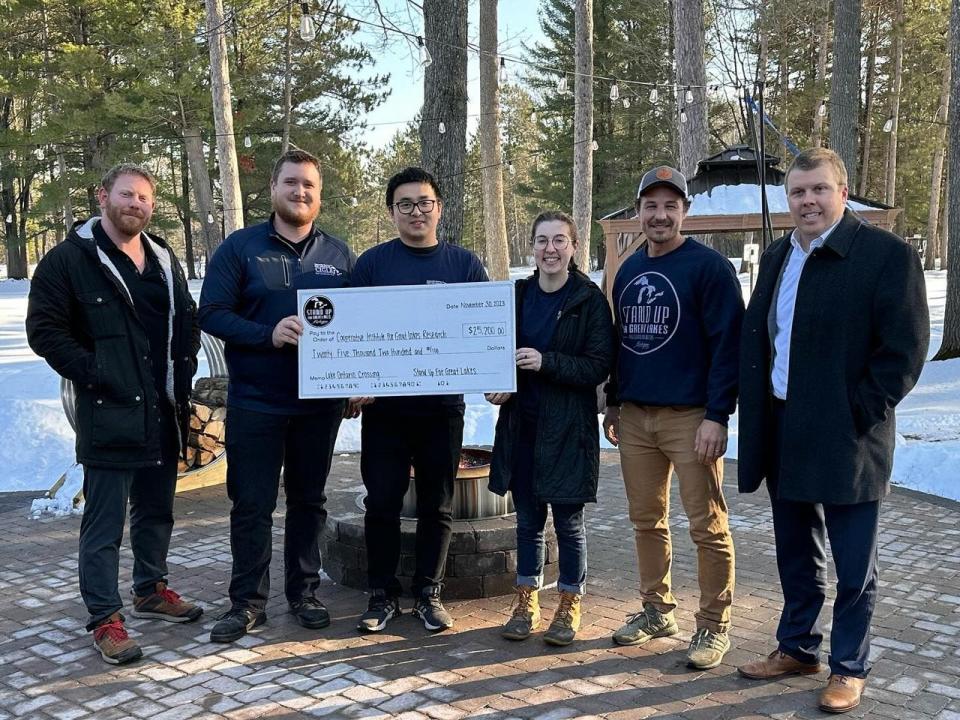 In December, Kwin Morris, Jeff Guy and Joe Lorenz presented a check to the Cooperative Institute for Great Lakes Research. The paddlers chose to donate money to the institute after their paddling across Lake Ontario. Researchers at the institute are working to improve weather forecasting models. Left to Right: Joe Lorenz, David Cannon, Yi Hong, Melissa Mattwig, Kwin Morris and Jeff Guy