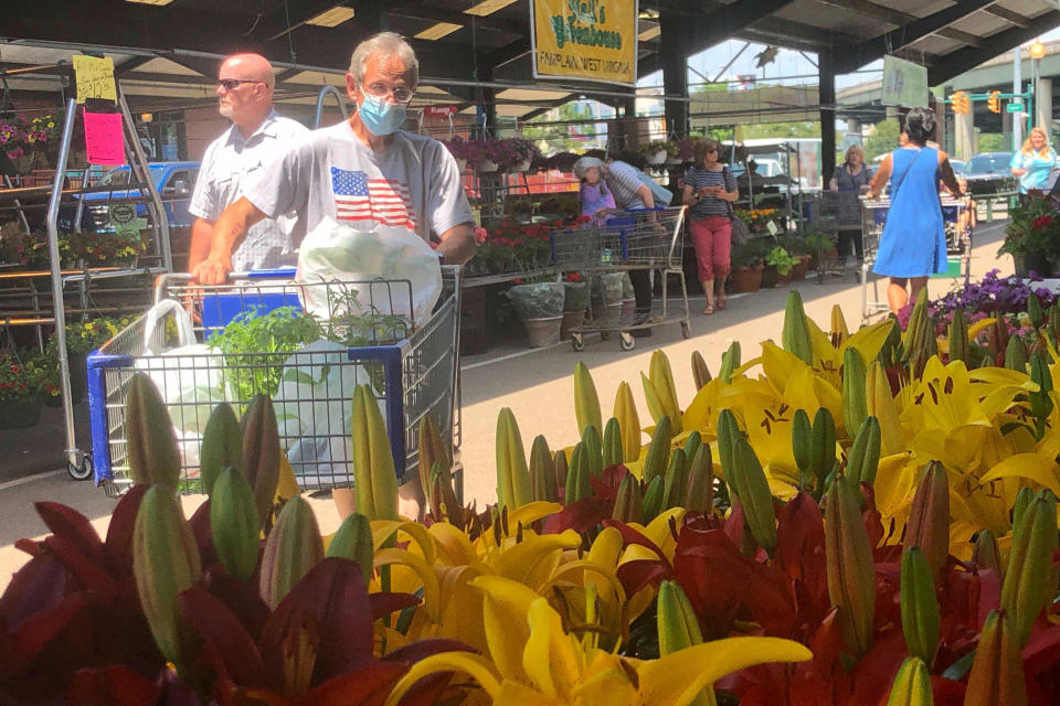 Shoppers look through offerings of flowers and vegetable plants Friday, May 22, 2021, at the Capitol Market in Charleston, W.Va. West Virginia has seen a higher percentage of residents depart than any other state in the past decade. (AP Photo/John Raby)