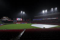 A trap covers the infield during a rain delay in the eighth inning of a baseball game between the Arizona Diamondbacks and the Cincinnati Reds in Cincinnati, Tuesday, April 20, 2021. (AP Photo/Aaron Doster)