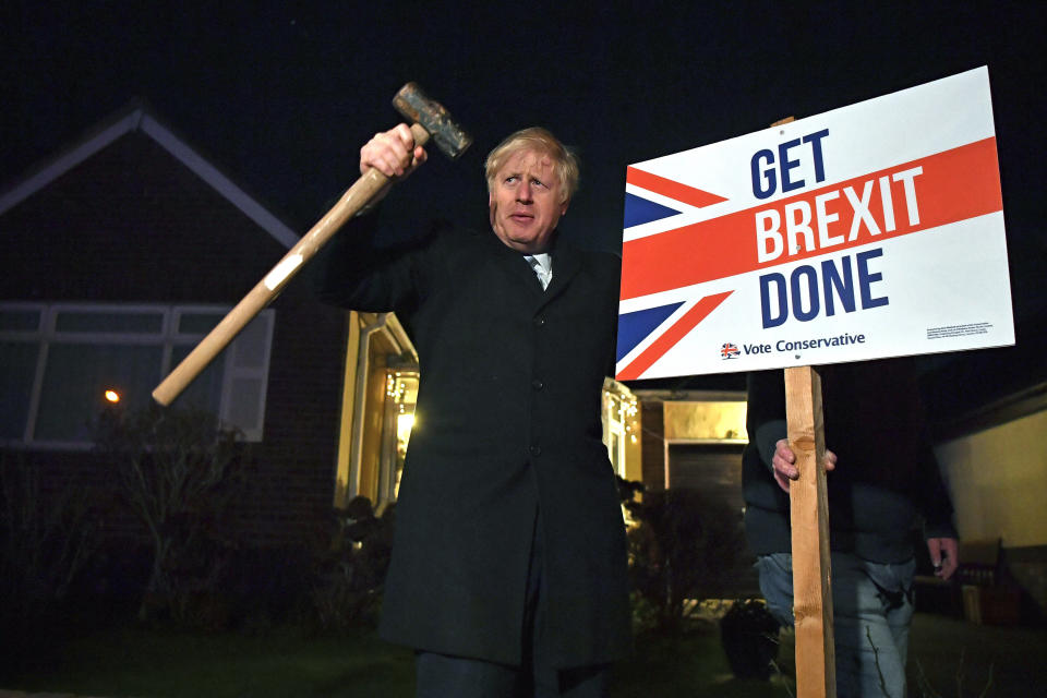 FILE - Britain's Prime Minister and Conservative party leader Boris Johnson poses as he hammers a sign into the garden of a supporter, in Benfleet, east of London on Wednesday, Dec. 11, 2019. When Johnson survived a no-confidence vote this week, at least one other world leader shared his relief. Ukrainian President Volodymyr Zelenskyy said it was “great news” that “we have not lost a very important ally.” It was a welcome endorsement for a British leader who divides his country, and his party, but has won wide praise as an ally of Ukraine. (Ben Stansall/Pool Photo via AP, File)