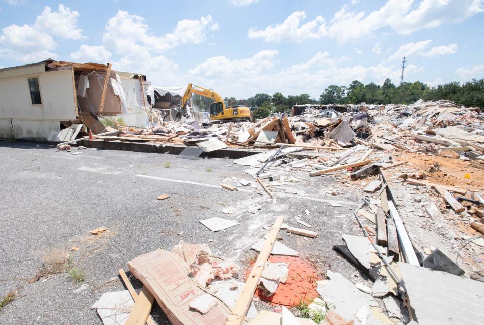 A crew from Virginia Wrecking demolishes the structures behind the old Santa Rosa County Court House in Milton on Friday, Aug. 18, 2023.
