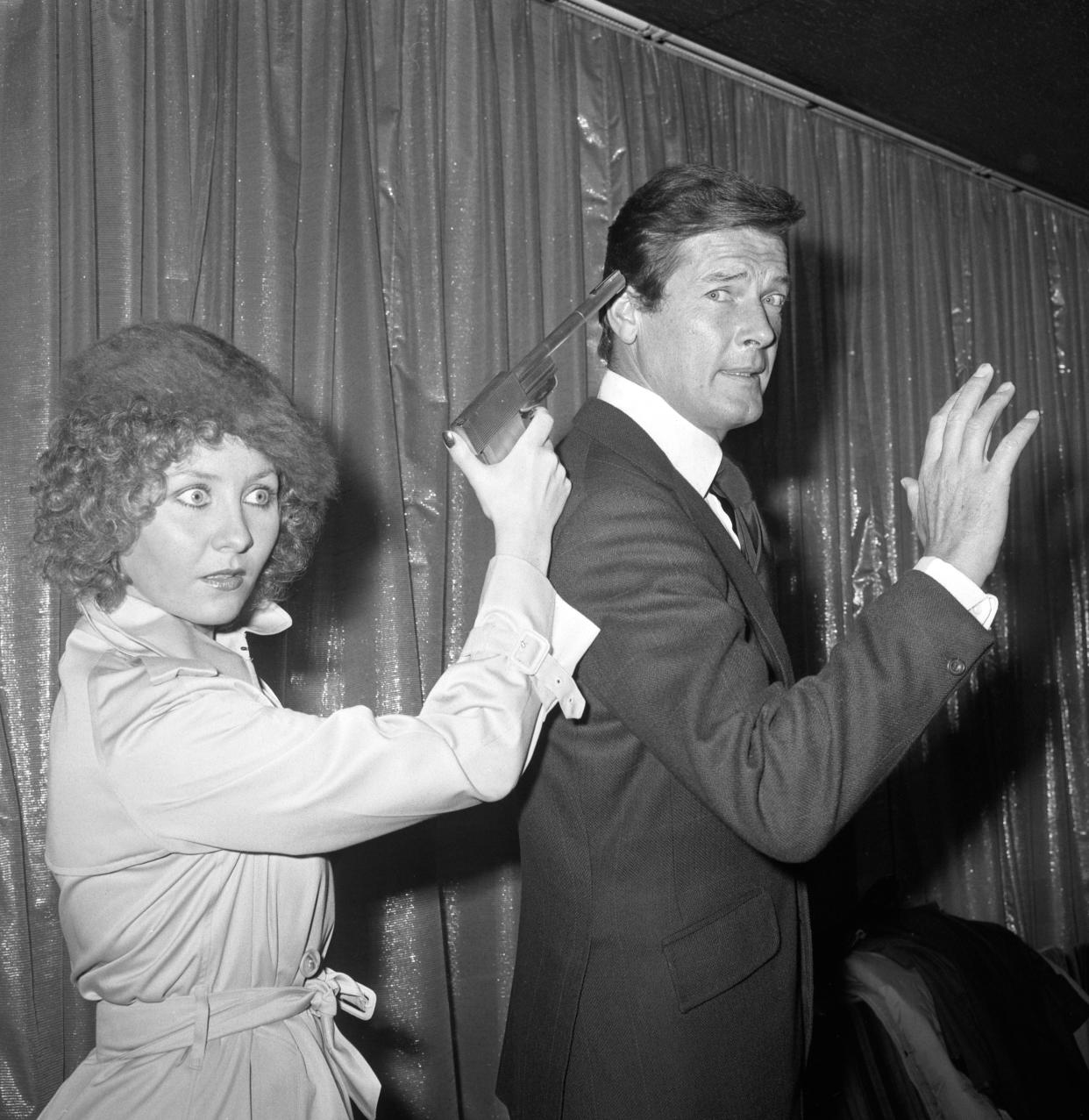 Roger Moore with Scottish singing star Lulu who had been signed to perform the title song for The Man with the Golden Gun.   (Photo by PA Images via Getty Images)