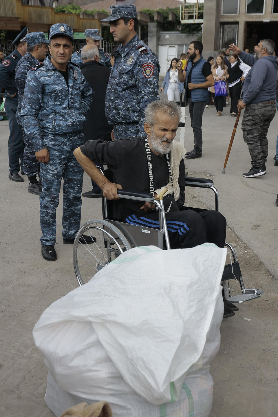 An ethnic Armenian from Nagorno-Karabakh sits in a wheelchair upon arrival in Armenia's Goris, the town in Syunik region, Armenia, Monday, Sept. 25, 2023. Thousands of Armenians have streamed out of Nagorno-Karabakh after the Azerbaijani military reclaimed full control of the breakaway region last week. (AP Photo/Vasily Krestyaninov)