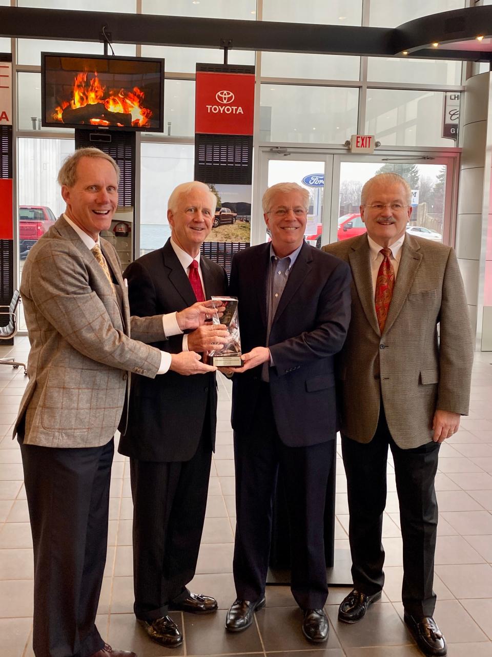 (Left to right) Bryan Graham, owner of Graham Toyota, and Clay Graham, owner and dealer principal, receive a 50-year anniversary award from Dave Fournier, market representation manager of Toyota Motor North America’s Cincinnati region. Also pictured is Ken Williams. vice president, operations Graham Auto Mall.