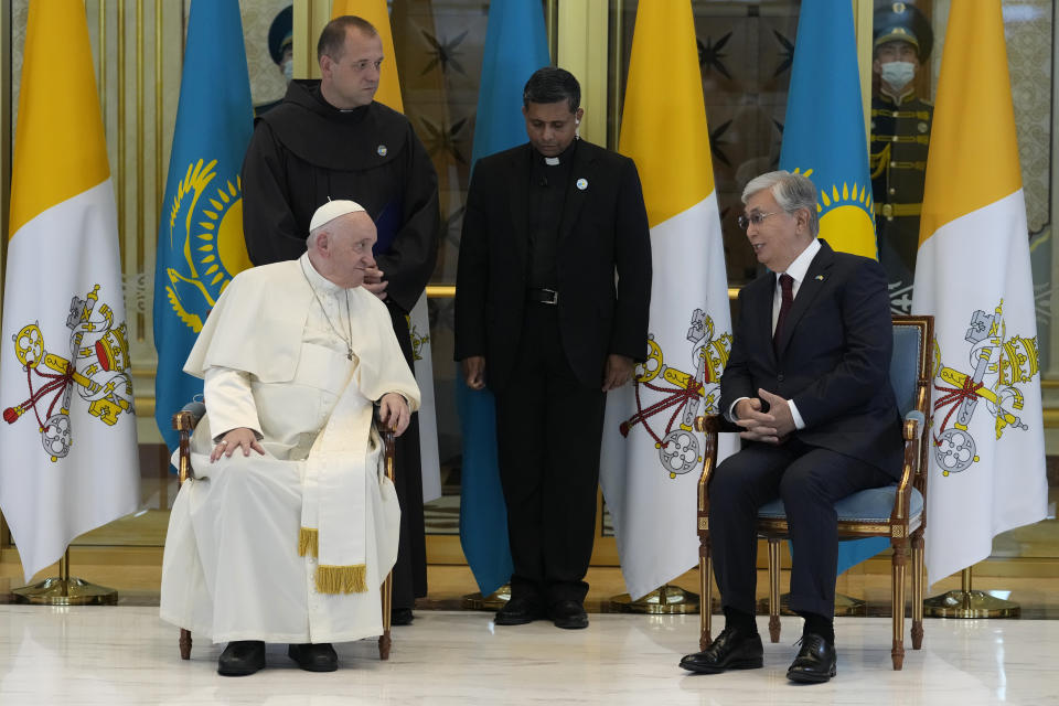 Pope Francis, left, meets the Kazakhstan's President Kassym-Jomart Tokayev as he arrives at Our-Sultan's International airport in Nur-Sultan, Kazakhstan, Tuesday, Sept. 13, 2022. Pope Francis begins a 3-days visit to the majority-Muslim former Soviet republic to minister to its tiny Catholic community and participate in a Kazakh-sponsored conference of world religious leaders. (AP Photo/Andrew Medichini)