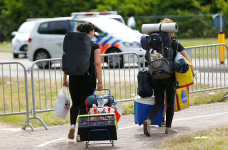 Visitors leave the festival grounds near a scene where a van struck into people after a concert at the Pinkpop festival in Landgraaf, the Netherlands June 18, 2018. REUTERS/Thilo Schmuelgen