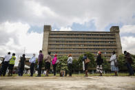 FILE - Kenyans line up to receive a dose of the AstraZeneca COVID-19 vaccine manufactured by the Serum Institute of India and provided through the global COVAX initiative, at Kenyatta National Hospital in Nairobi, Tuesday, April 6, 2021. COVAX, created to share coronavirus vaccines fairly, already scaled back its pledge to the world's poor once. Now, to meet even that limited promise, it would have to deliver more than a million doses every hour until the end of the year. (AP Photo/Brian Ingasnga, File)