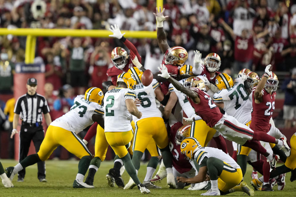 Green Bay Packers kicker Mason Crosby (2) kicks the game winning field goal from the hold of Corey Bojorquez during the second half of an NFL football game against the San Francisco 49ers in Santa Clara, Calif., Sunday, Sept. 26, 2021. (AP Photo/Tony Avelar)