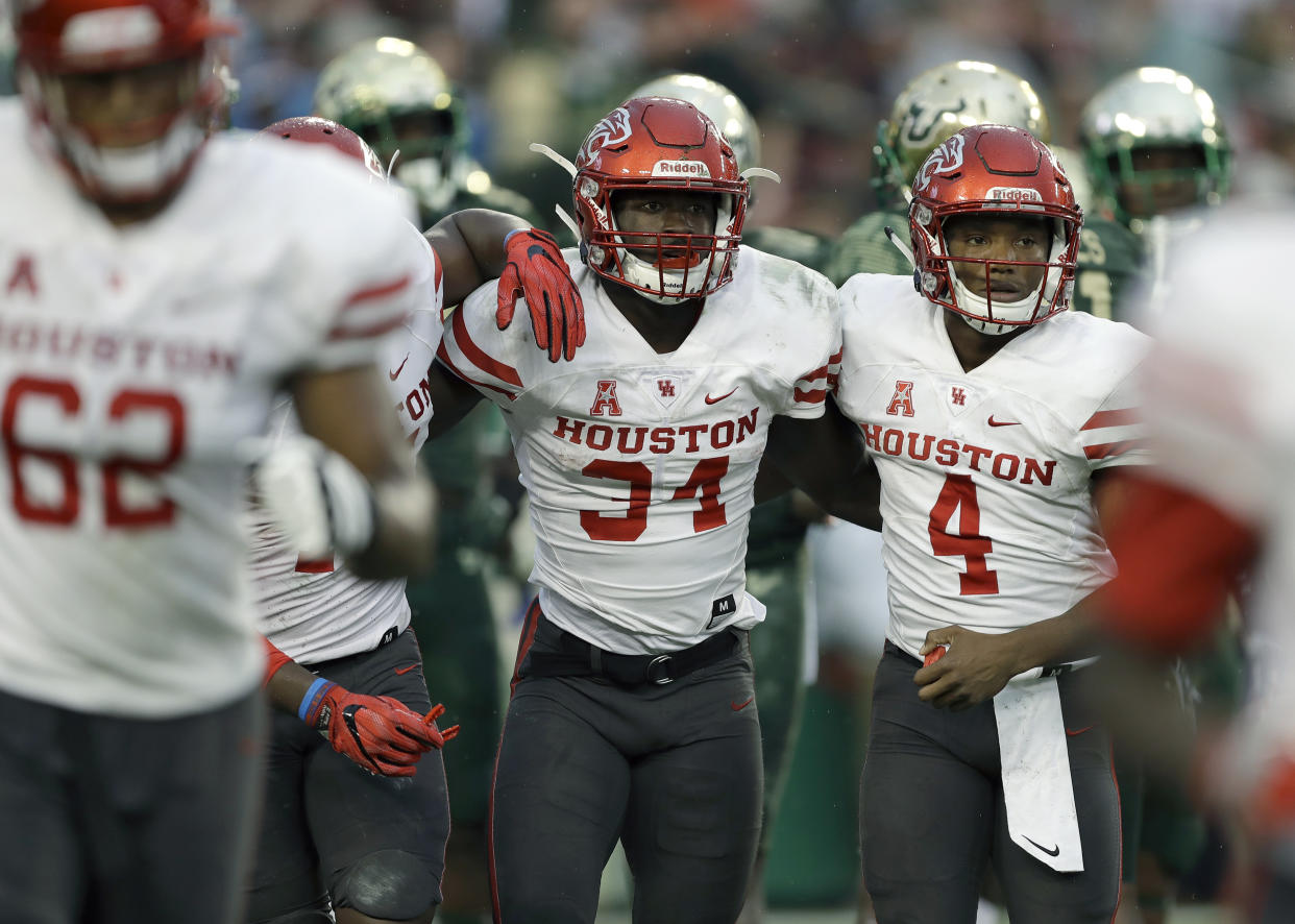 Houston running back Mulbah Car (34) celebrates with quarterback D’Eriq King (4) after scoring on a 4-yard touchdown run against South Florida during the second half of an NCAA college football game, Saturday, Oct. 28, 2017, in Tampa, Fla. Houston upset South Florida 28-24. (AP Photo/Chris O’Meara)
