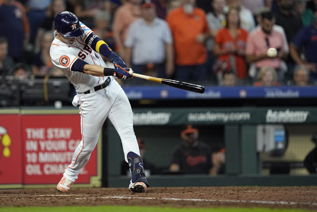 Houston Astros shortstop Mauricio Dubon (14) hits an RBI single to