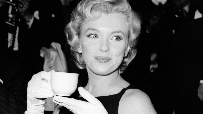 Marilyn Monroe holding a drink