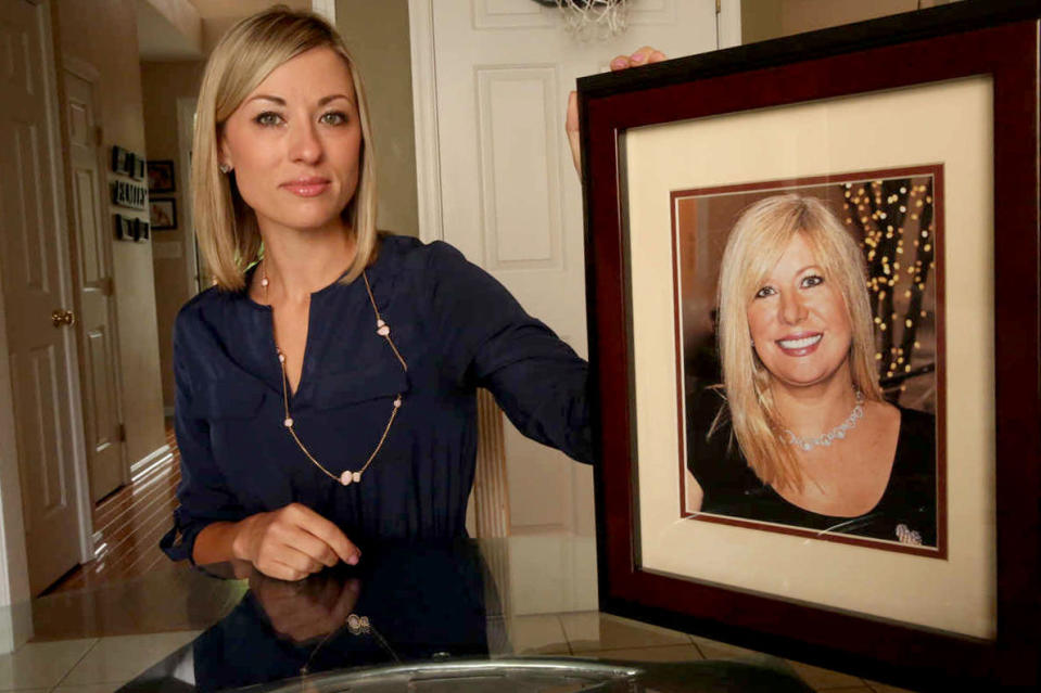 Kim Pack poses with a photo of her late mother, talk-show host April Kauffman, in Linwood, N.J.