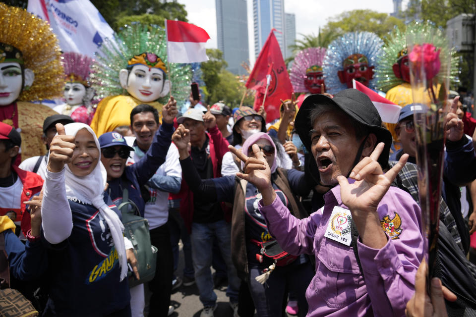 Supporters of presidential candidate Ganjar Pranowo cheer as they wait for his arrival to officially register his candidacy to run in the 2024 election, at the General Election Commission building in Jakarta, Indonesia, Thursday, Oct. 19, 2023. The world's third-largest democracy is set to vote in simultaneously legislative and presidential elections on Feb. 14, 2024. (AP Photo/Achmad Ibrahim)