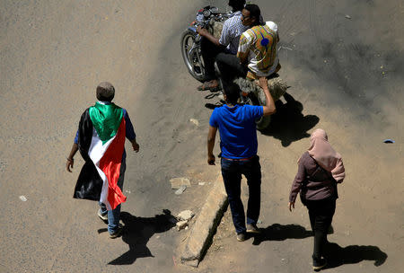 A Sudanese demonstrator wears the national flag during a protest demanding Sudanese President Omar Al-Bashir to step down in Khartoum, Sudan April 6, 2019. REUTERS/Stringer