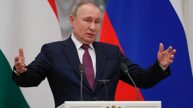 Russian President Vladimir Putin gestures while speaking to the media