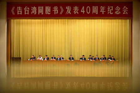 A banner is reflected on a polished surface as Chinese President Xi Jinping (C) speaks during an event to commemorate the 40th anniversary of the "Message to Compatriots in Taiwan" at the Great Hall of the People in Beijing, China January 2, 2019. REUTERS/Mark Schiefelbein/Pool TPX IMAGES OF THE DAY