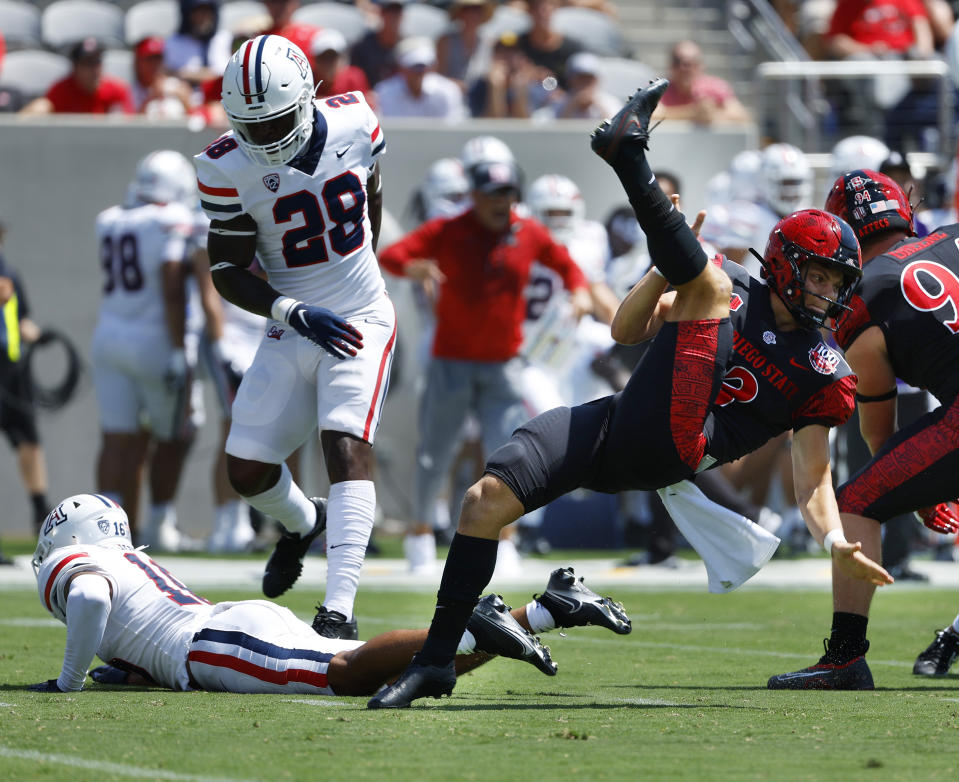 San Diego State's Jack Browning (13) has a punt blocked by Arizona's Dalton Johnson in the second quarter at Snapdragon Stadium on Saturday, Sept. 3, 2022 in San Diego, Calif. (K.C. Alfred/The San Diego Union-Tribune via AP)